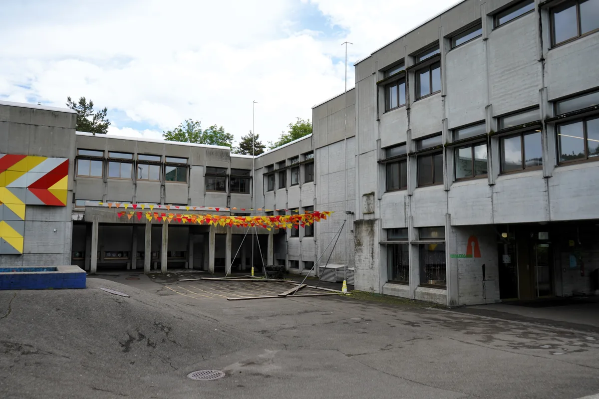 Man sieht ein Schulhausgebäude im Betonbau.